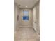 Entryway with tile flooring, a white door, a light fixture, and two windows with blinds at 3041 Savella Ave, Henderson, NV 89044