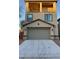 Two-story home featuring a two-car garage, balcony, and desert landscaping at 3041 Savella Ave, Henderson, NV 89044