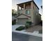 Tan three-story house with a balcony and garage at 3041 Savella Ave, Henderson, NV 89044