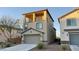 Two-story home featuring a two-car garage, balcony, and desert landscaping at 3041 Savella Ave, Henderson, NV 89044