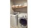 Functional laundry area with modern washer and dryer and storage shelves at 3041 Savella Ave, Henderson, NV 89044