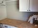 Bright laundry room with wooden countertop and cabinets at 3041 Savella Ave, Henderson, NV 89044