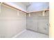 Spacious walk-in closet with wood shelving and concrete accent wall at 353 E Bonneville Ave # 385, Las Vegas, NV 89101