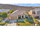 Aerial view of single-story house with tile roof, landscaped yard, and driveway at 37 Stonemark Dr, Henderson, NV 89052