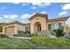 Single-story home's exterior features a tile roof, arched entryway, and manicured landscaping at 37 Stonemark Dr, Henderson, NV 89052