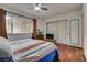 Spacious bedroom with wood floors, large window, and sliding mirrored closet doors at 3767 Monument St, Las Vegas, NV 89121