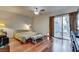 Bedroom with wood floors, a ceiling fan, and sliding glass doors to a patio at 3767 Monument St, Las Vegas, NV 89121