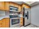 Kitchen boasts stainless steel appliances and oak cabinets at 3767 Monument St, Las Vegas, NV 89121