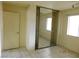 Bedroom with mirrored closet and tile floors at 384 Norlina Ct, Henderson, NV 89014