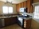 View of kitchen with granite countertops and appliances at 384 Norlina Ct, Henderson, NV 89014