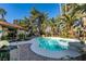 Inviting backyard oasis featuring a sparkling pool and spa, surrounded by lush landscaping at 3990 Melody Ln, Las Vegas, NV 89108