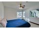 Bright bedroom with a blue comforter and view of the backyard at 3990 Melody Ln, Las Vegas, NV 89108