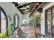 Covered patio with terracotta tile flooring and lush plants at 3990 Melody Ln, Las Vegas, NV 89108