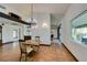 Bright dining room with a chandelier, tile floors, and built-in cabinetry at 3990 Melody Ln, Las Vegas, NV 89108