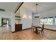 Bright dining room with a chandelier, tile floors, and built-in cabinetry at 3990 Melody Ln, Las Vegas, NV 89108