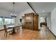 Bright dining room with a chandelier, tile floors, and built-in cabinetry at 3990 Melody Ln, Las Vegas, NV 89108