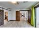 Hallway with light wood flooring and rustic barn doors at 3990 Melody Ln, Las Vegas, NV 89108