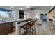 Kitchen features a breakfast bar, stone backsplash and stainless steel appliances at 3990 Melody Ln, Las Vegas, NV 89108