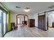 Living room features wood-like tile floors and a rustic barn door at 3990 Melody Ln, Las Vegas, NV 89108