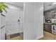 Modern entryway with wood floors, white door, and view into kitchen at 4070 Emerald Wood St, Las Vegas, NV 89115