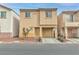 Tan two-story house with attached garage and small front yard at 4070 Emerald Wood St, Las Vegas, NV 89115