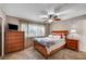 Spacious bedroom with a dresser, ceiling fan, and large windows at 4089 Patterson Ave, Las Vegas, NV 89104