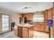 Modern kitchen featuring oak cabinets, granite countertops, and a large island at 4089 Patterson Ave, Las Vegas, NV 89104