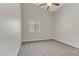 Well lit bedroom with ceiling fan and carpet flooring at 4176 Demoline Cir, Las Vegas, NV 89141