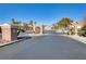 Gated entrance to Bella Vicenza community with palm trees and landscaping at 4176 Demoline Cir, Las Vegas, NV 89141