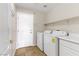 Laundry room with washer, dryer, and storage shelves at 4176 Demoline Cir, Las Vegas, NV 89141