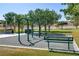 playground with swings and a bench, surrounded by trees at 4176 Demoline Cir, Las Vegas, NV 89141