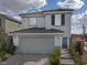 Two-story house with gray siding, a two-car garage, and landscaping at 4199 Nopal Serrano Ave, Las Vegas, NV 89141