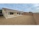 Large backyard with gravel, covered patio, and block wall at 4290 S Gressa St, Pahrump, NV 89061