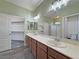 Double vanity bathroom with wood cabinets and walk-in closet at 4290 S Gressa St, Pahrump, NV 89061