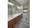 Double vanity bathroom with wood cabinets and grey flooring at 4290 S Gressa St, Pahrump, NV 89061