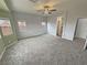 Bright bedroom with grey carpet and ceiling fan at 4290 S Gressa St, Pahrump, NV 89061