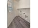 Laundry room with window, vinyl flooring and built in shelving at 4290 S Gressa St, Pahrump, NV 89061