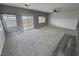 Spacious living room with carpeting and access to backyard patio at 4290 S Gressa St, Pahrump, NV 89061