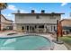 Backyard view of house with pool, outdoor dining, and well-maintained landscaping at 4330 Flandes St, Las Vegas, NV 89121