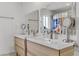 Bathroom with double vanity, wood cabinets, and tiled floors at 4330 Flandes St, Las Vegas, NV 89121