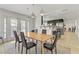 Open-concept dining area with a modern table and chairs, stylish pendant lighting, and access to the backyard patio at 4330 Flandes St, Las Vegas, NV 89121