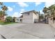 Two-story home featuring a spacious driveway, two-car garage, and gated yard for added privacy in a residential neighborhood at 4330 Flandes St, Las Vegas, NV 89121