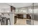 Updated kitchen featuring dark cabinetry, granite counters, and stainless steel appliances at 4330 Flandes St, Las Vegas, NV 89121