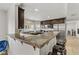 Modern kitchen with dark wood cabinets, granite countertops, and stainless steel appliances at 4330 Flandes St, Las Vegas, NV 89121