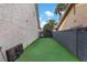 Side yard with artificial turf, enclosed by a block fence, offering a private outdoor space at 4330 Flandes St, Las Vegas, NV 89121