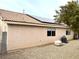 Back of house with solar panels and gravel backyard at 4618 Zia Ridge St, North Las Vegas, NV 89031