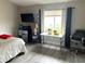 Cozy bedroom featuring gray walls, bright natural light, and modern furnishings at 4618 Zia Ridge St, North Las Vegas, NV 89031