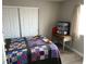 Cozy bedroom with a patchwork quilt and built-in closet at 4618 Zia Ridge St, North Las Vegas, NV 89031