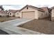 Tan single-story house with red tiled roof, two-car garage, concrete driveway, and desert landscaping at 4618 Zia Ridge St, North Las Vegas, NV 89031