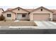 Single-story house with a two-car garage and desert landscaping at 4618 Zia Ridge St, North Las Vegas, NV 89031